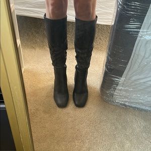 Black heeled knee high boots